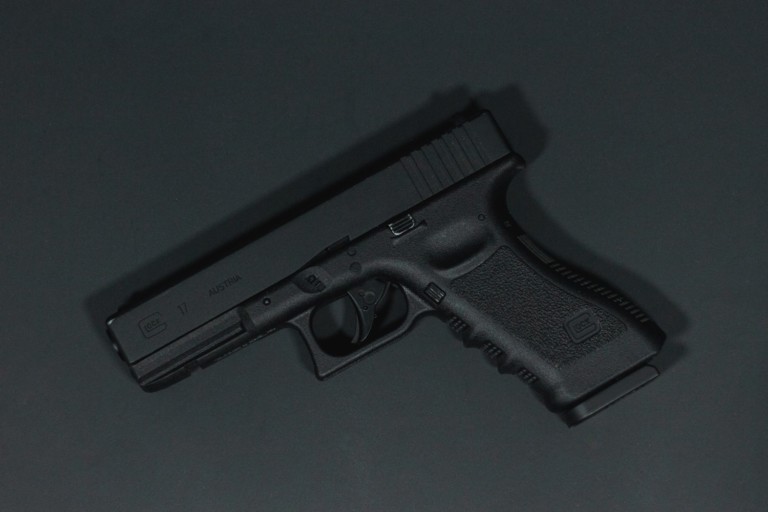 black semi automatic pistol on gray surface