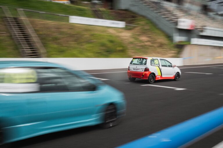 a small car driving down a race track